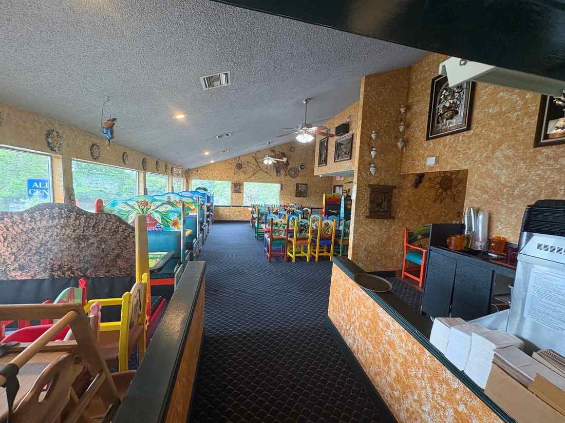 Family dining room inside 2 Margaritas Allyn with colorful chairs, booths and spacious seating
