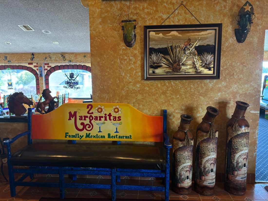 Guest waiting bench and decorative artwork inside 2 Margaritas Allyn